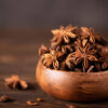 star anise in a wooden bowl on the table, close up Star Anise